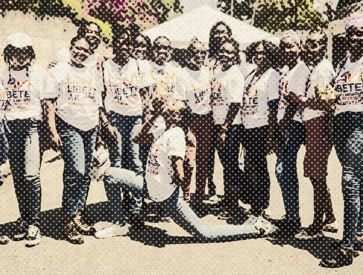 NÈGÈS MAWON members in matching white t-shirts, gathered for a group photograph