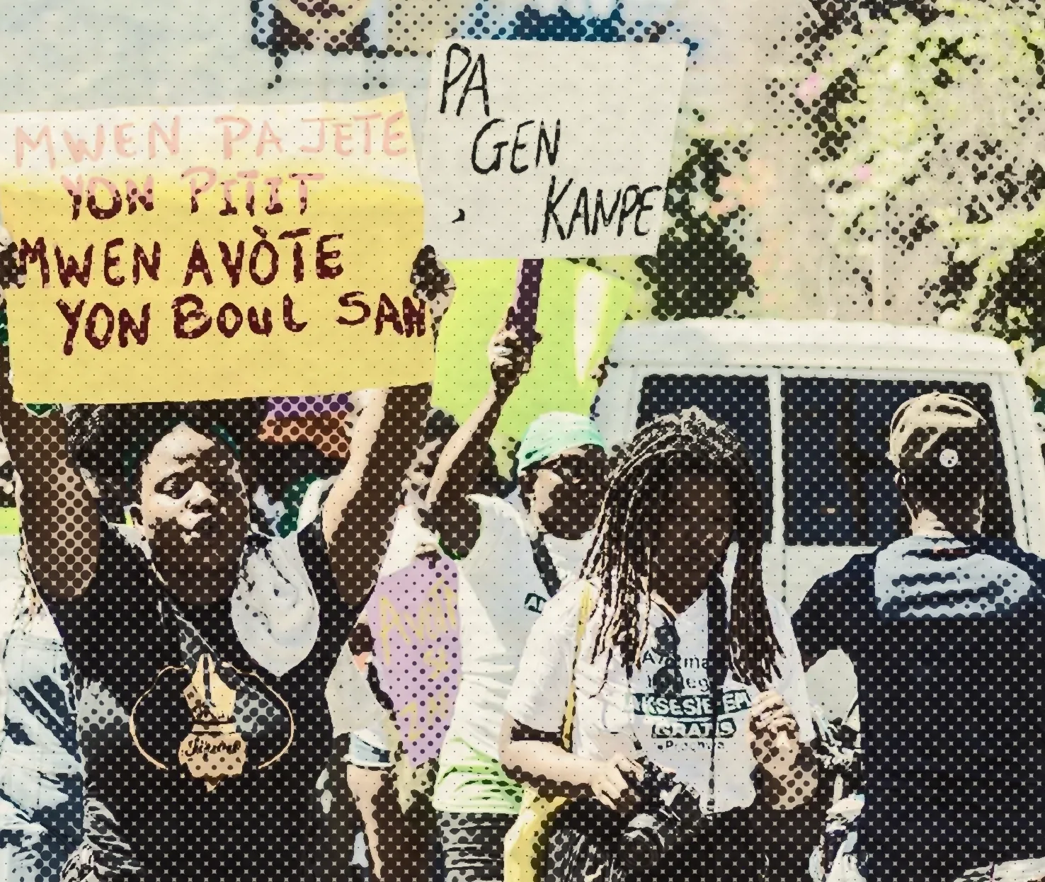 Protesters holding hand-lettered placards at a NÈGÈS MAWON march