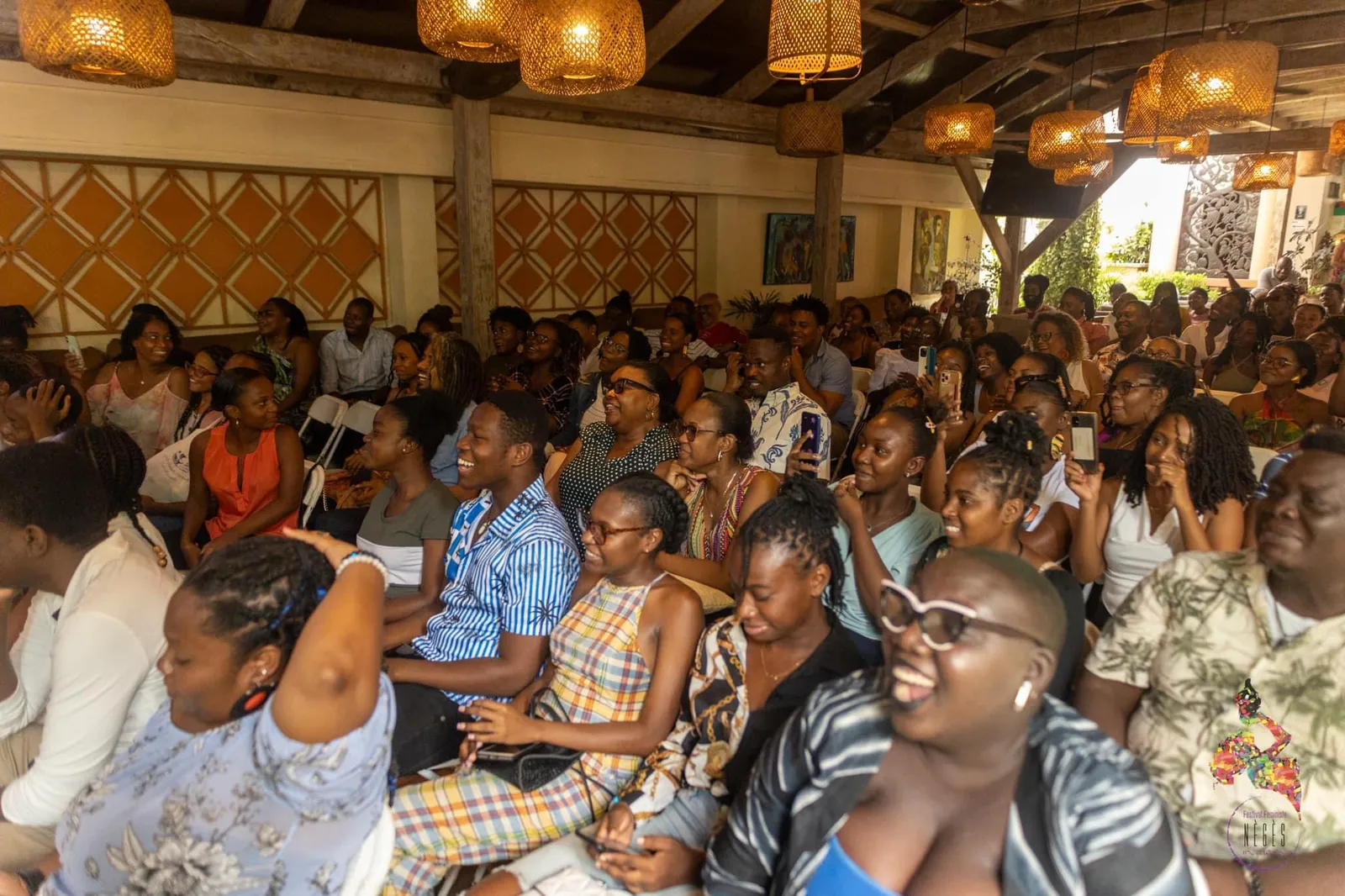 A full audience under a wooden roof